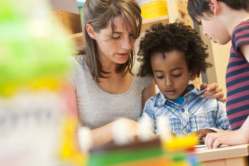 An adult and child reading together